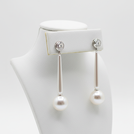 Classic pearl drop earrings on velvet stand